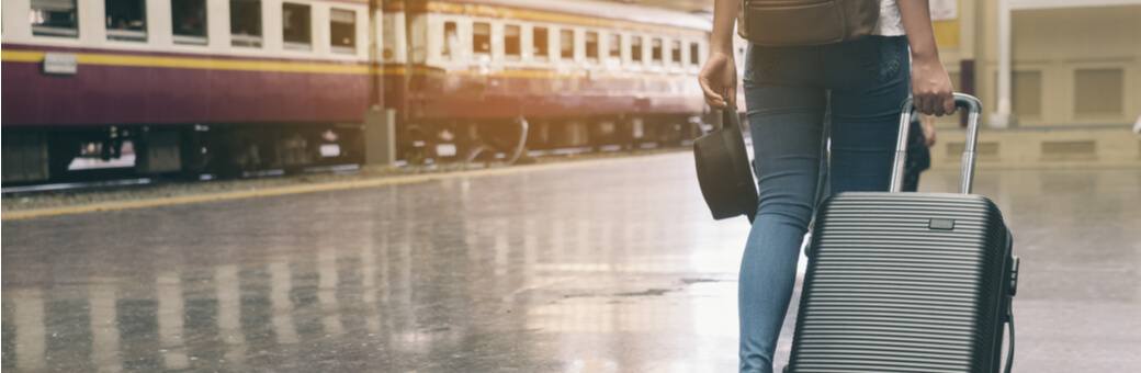 Man pulling a suitcase on a train platform
